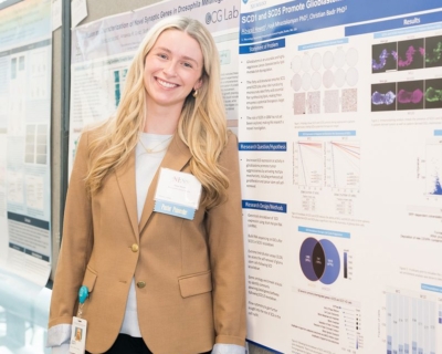 bscp student standing in front of poster presentation smiling 