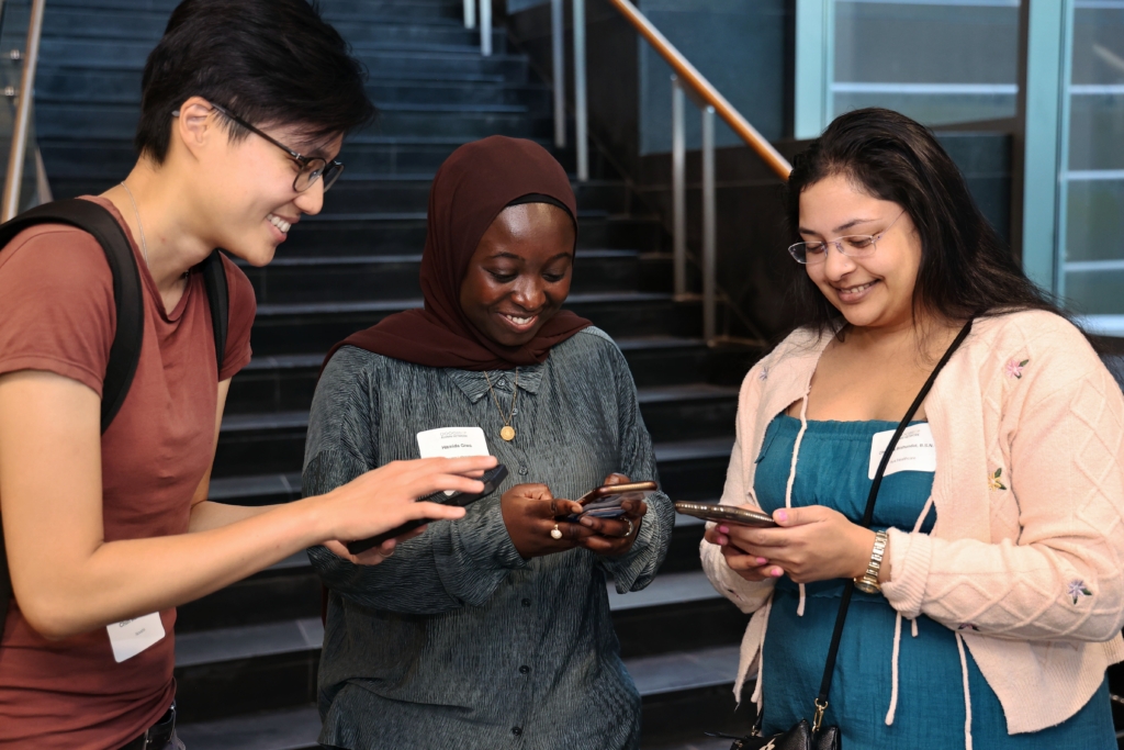 three students all on their phone