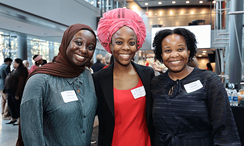 BSCP alumni smiling and looking at camera at alumni conference
