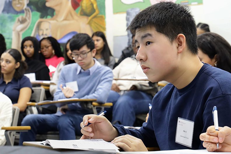 students in classroom writing, paying attention