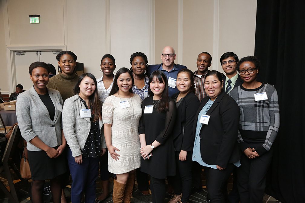 group of students and advisor smiling at camera