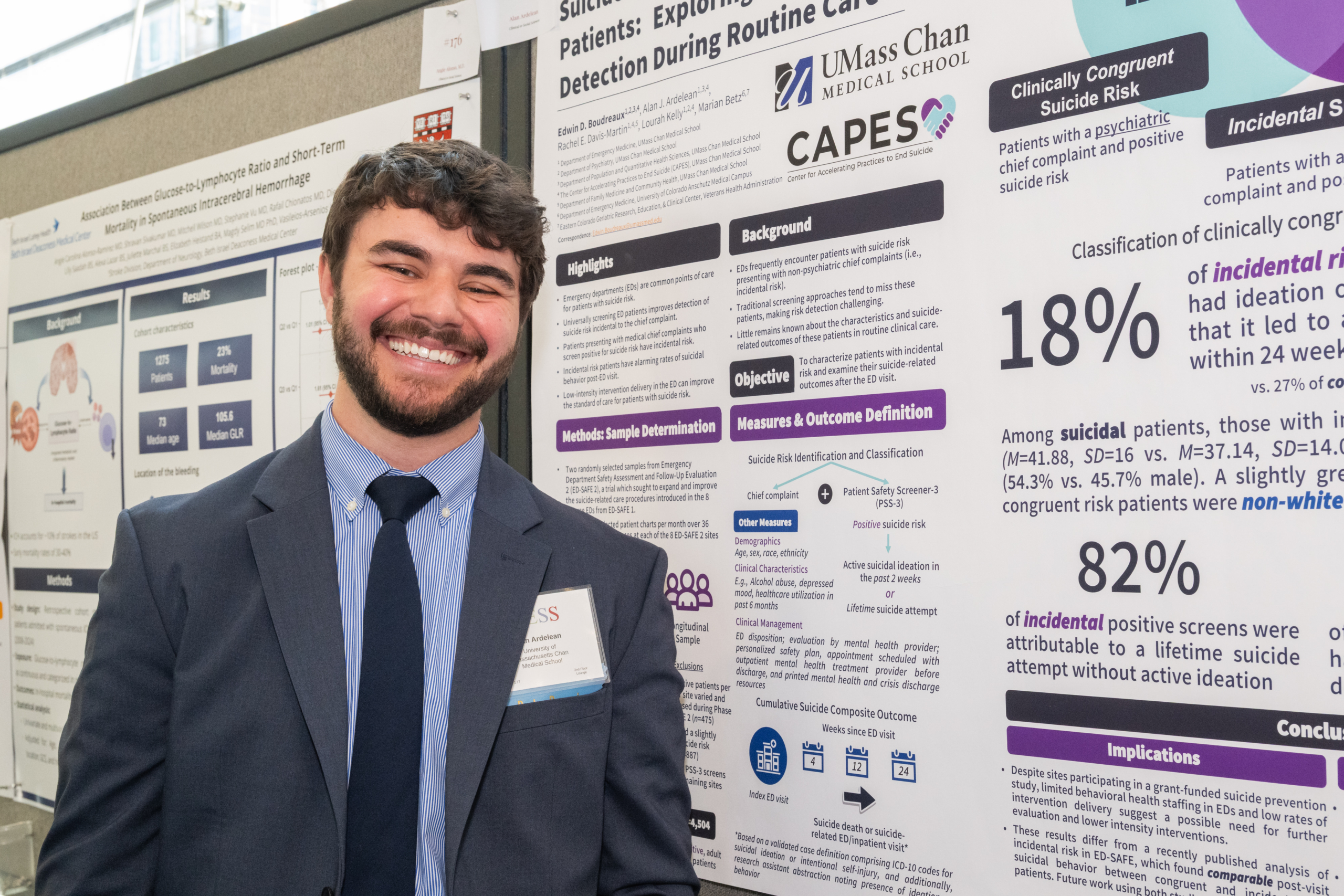 student standing with poster presentation showing research