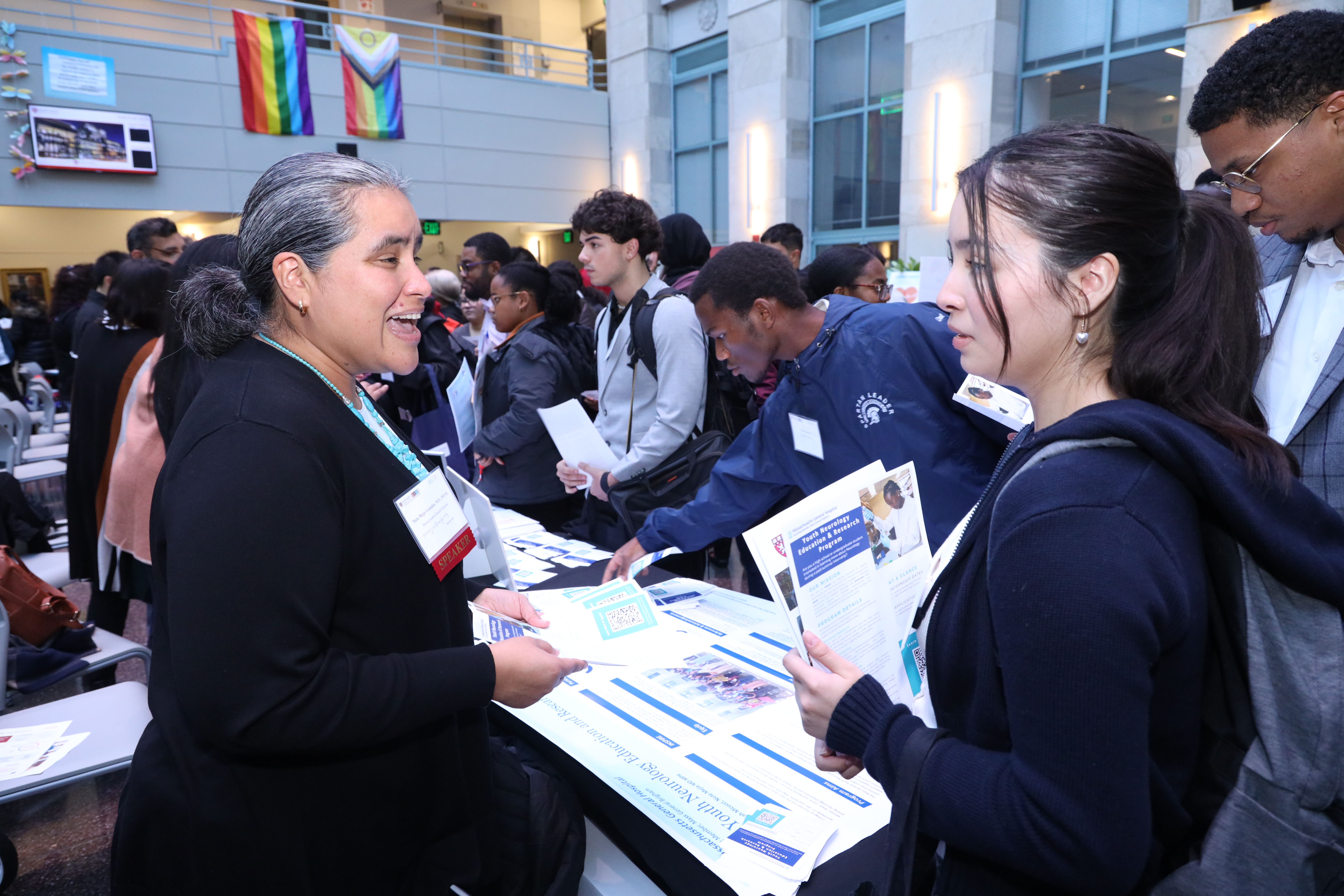 student talking to someone at an info table at internship fair