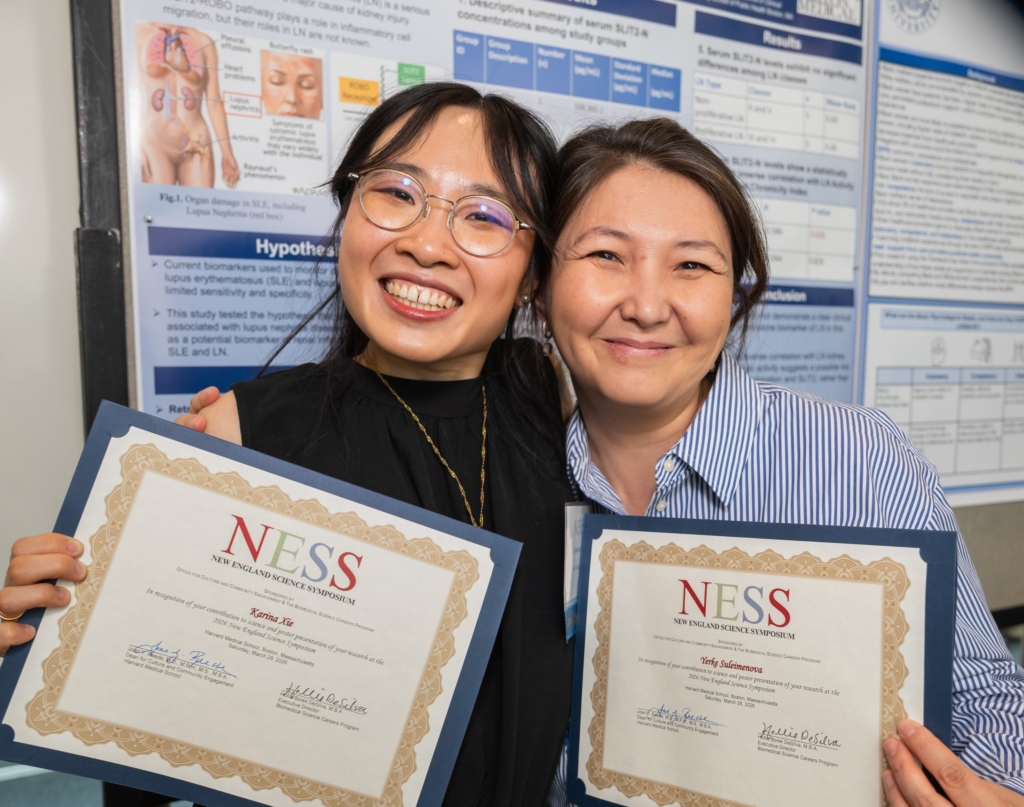 two women holding certificates posed for camera